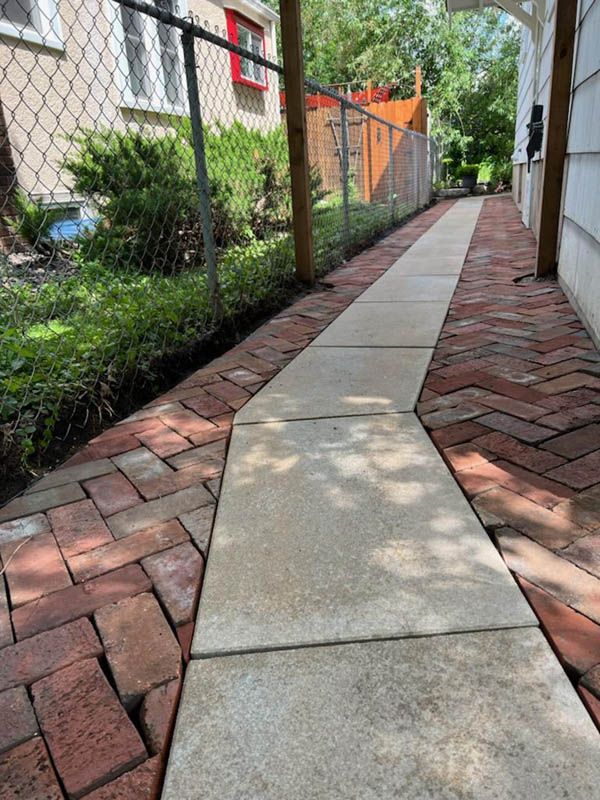 Cement walkway with a brick border