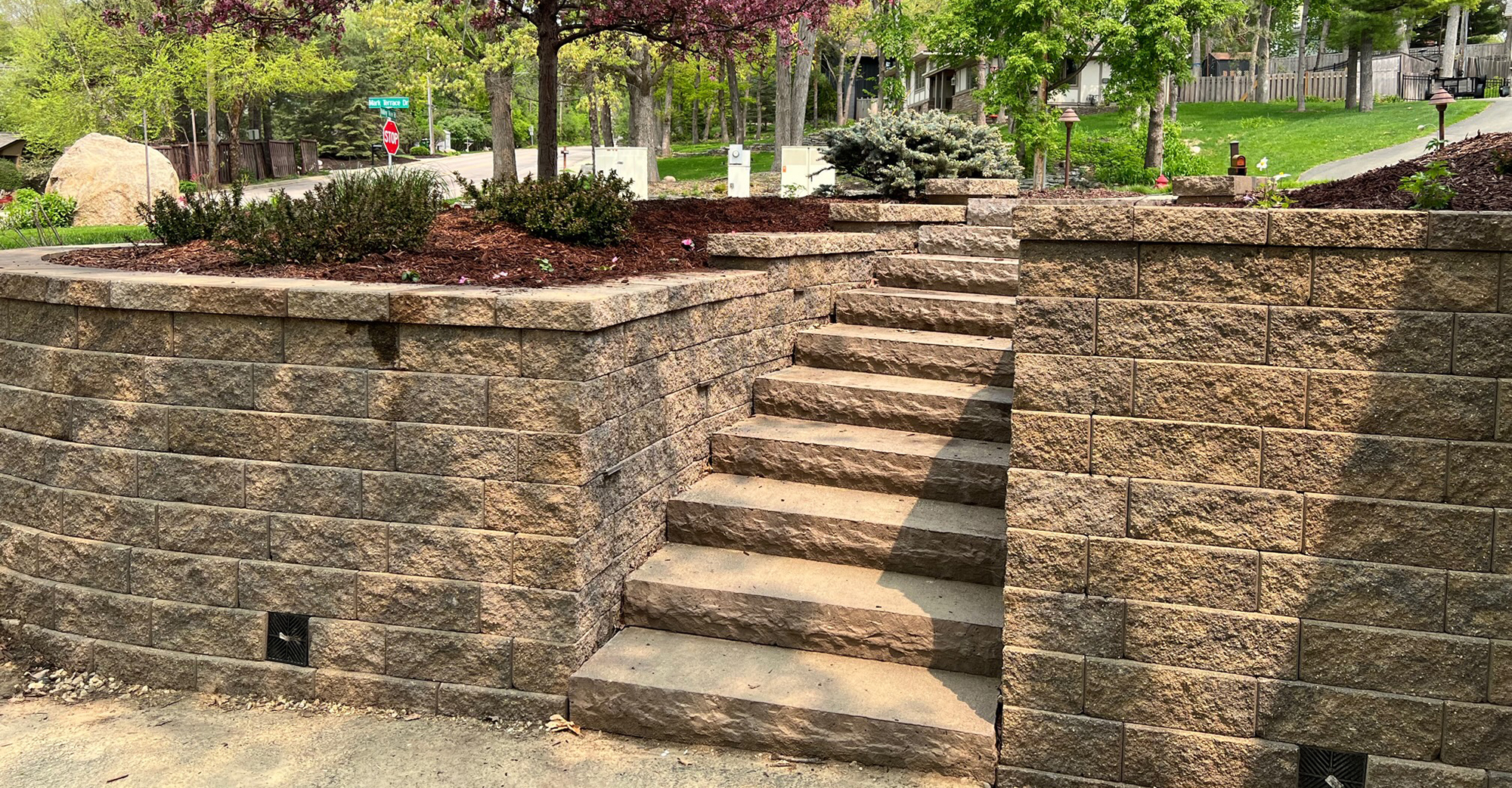 Retaining wall with paver stairs that lead up it