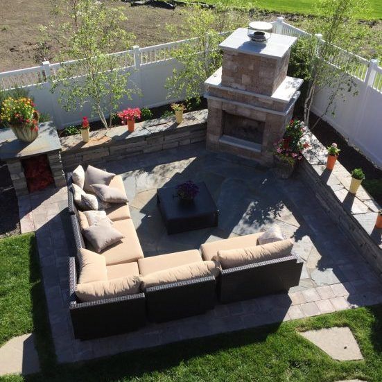 Patio with an outdoor fireplace and sectional sofa