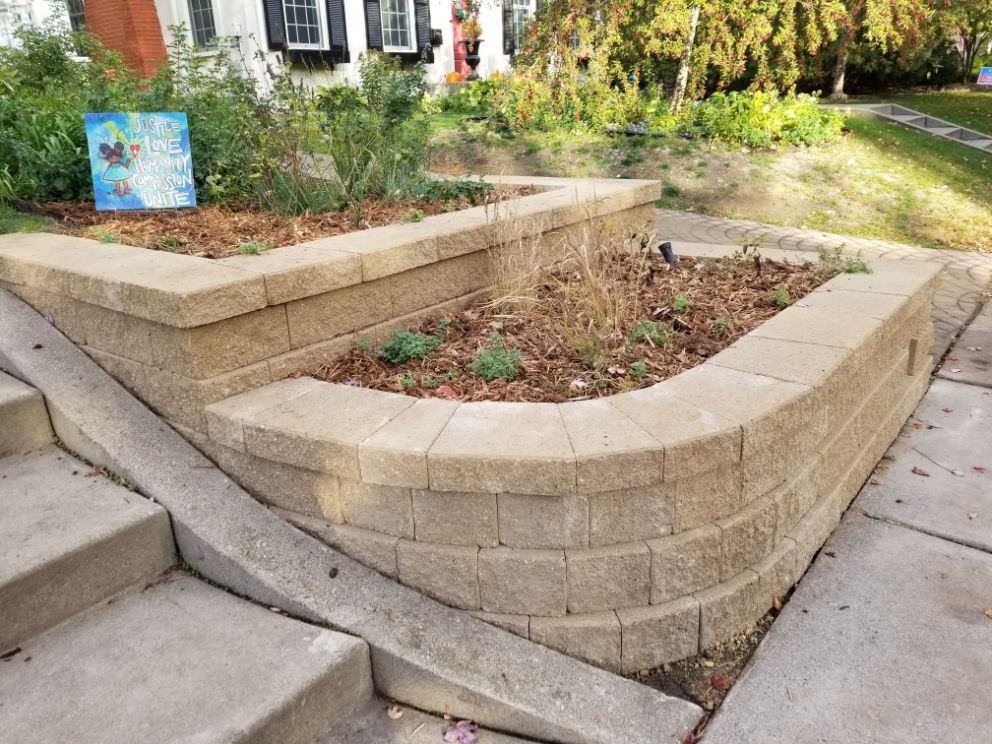 Two-tiered retaining wall and rain garden near a patio