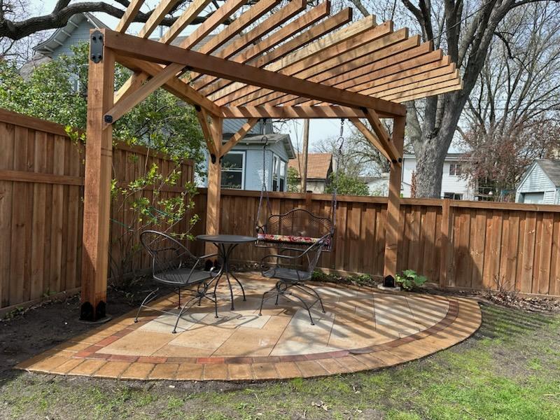 Custom cedar pergola over a circular paver patio in an Edina, MN backyard