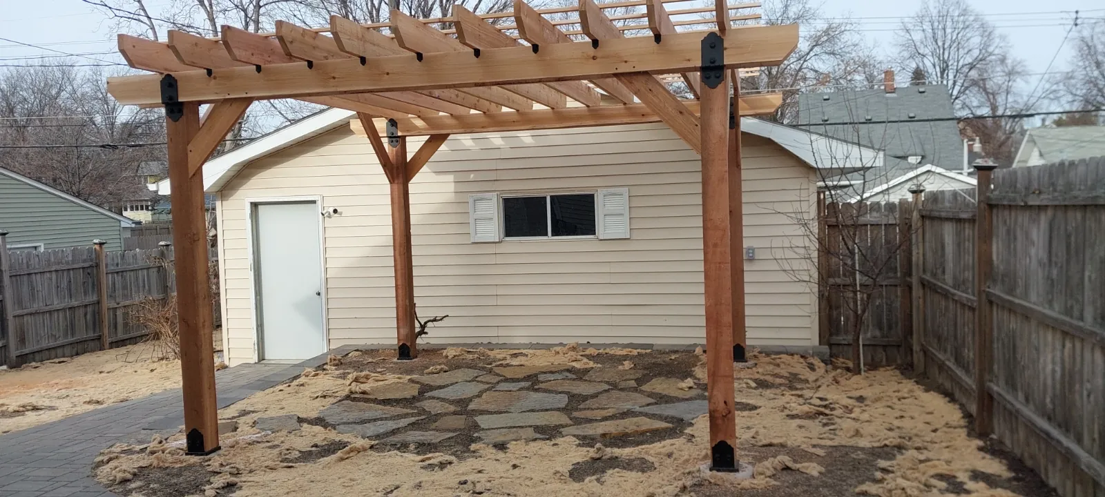 Custom cedar pergola over a backyard patio at a home in Eagan, MN
