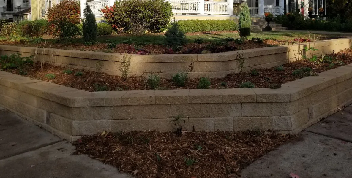 Tiered stone retaining wall in a St. Paul residential landscape